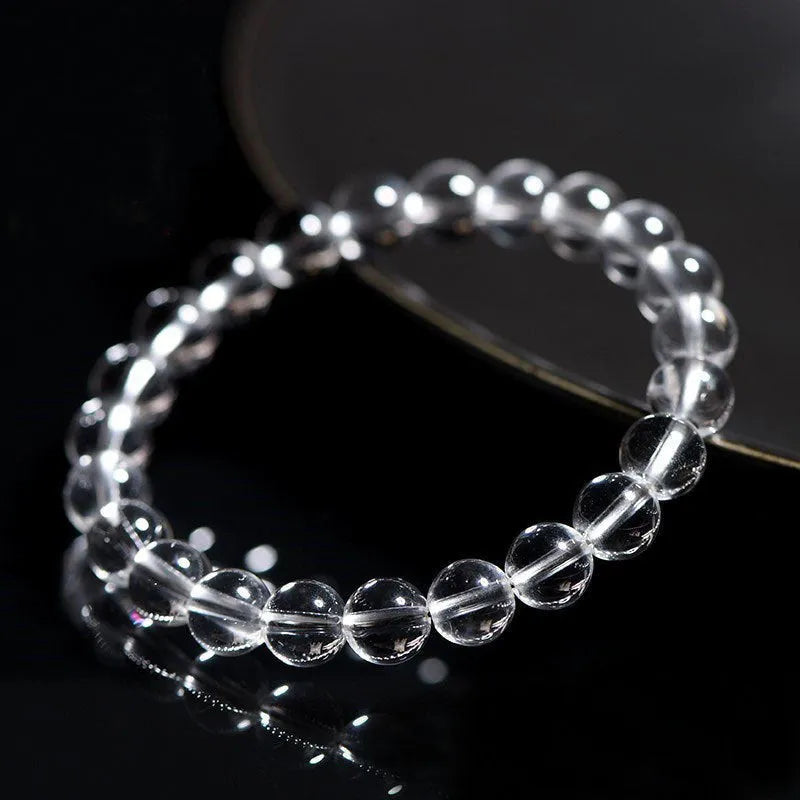 Natural white crystal bead bracelet with geometric design and round beads in various sizes.
