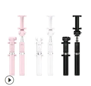 Aluminium Bluetooth selfie stick with tripod base and remote control next to a mobile phone.