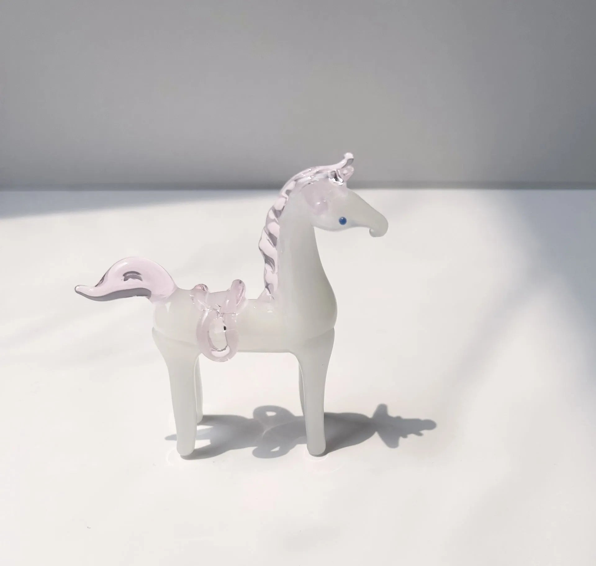 Coloured glaze horse sculpture in brown finish on wooden desk