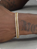 Gold tennis bracelet with artificial gemstone details on titanium steel band