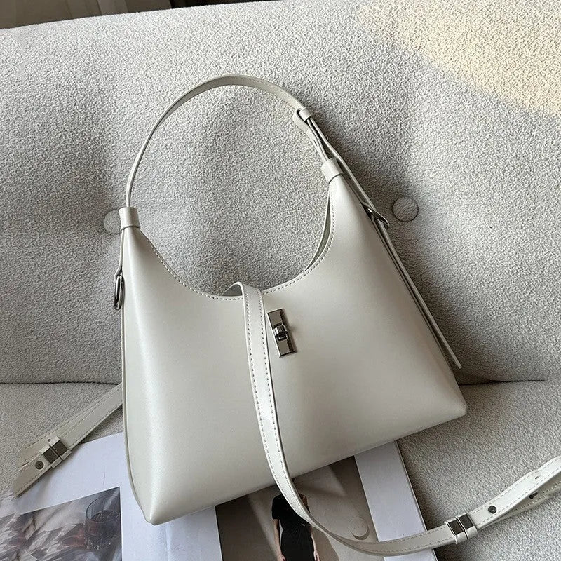 Genuine leather dumpling-shaped crossbody shoulder bag in apricot colour with a front sandwich pocket.