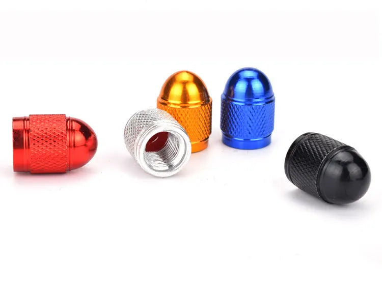 Aluminium alloy mountain bike tyre valve cap in multiple colour choices on a bicycle wheel.
