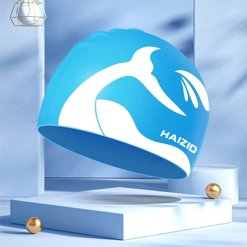 Silicone swimming cap with waterproof ear protectors showing whale tail pattern in multiple colour options
