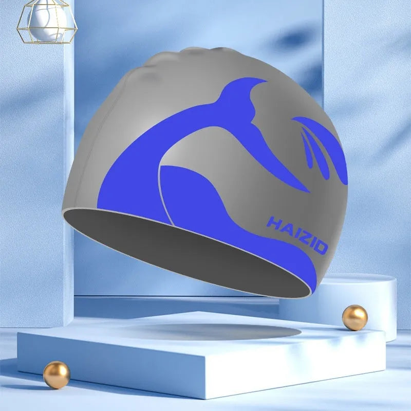 Silicone swimming cap with waterproof ear protectors showing whale tail pattern in multiple colour options