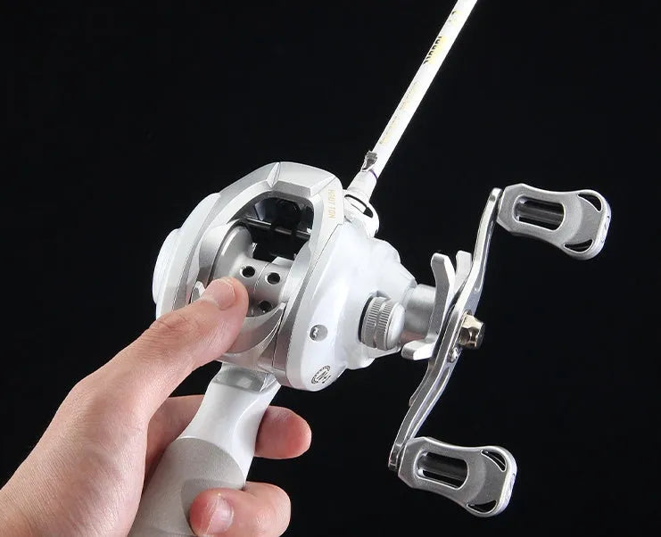 Small white micro baitcasting fishing reel with a distinctive drip wheel design on a blue background.