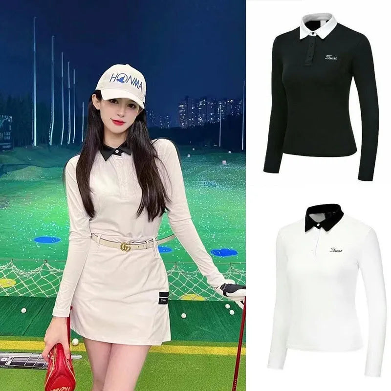 Women's slim-fit long sleeve polyester golf top in black on a hanger.