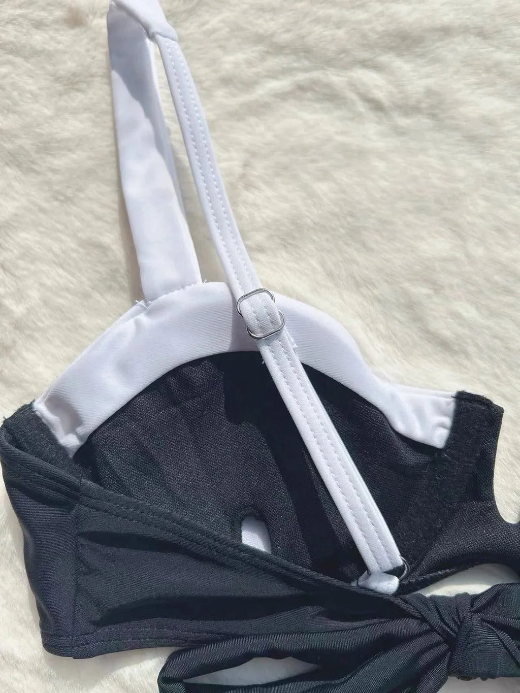 Black women's low waist bikini swimsuit with split stitching detail on the briefs.