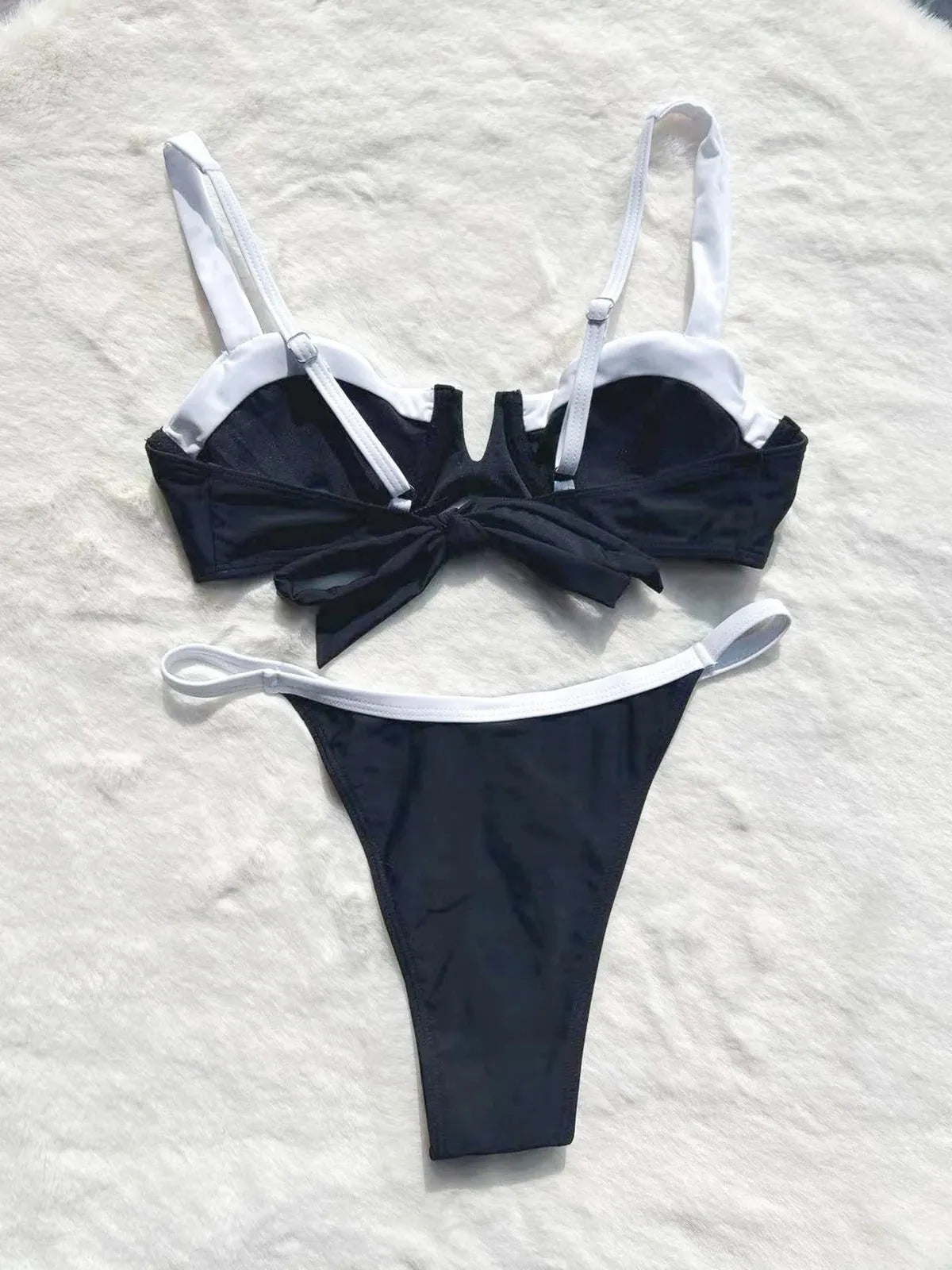 Black women's low waist bikini swimsuit with split stitching detail on the briefs.