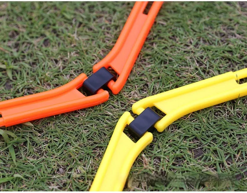 Six foldable yellow, green, and orange hexagon football agility training rings laid out on grass.
