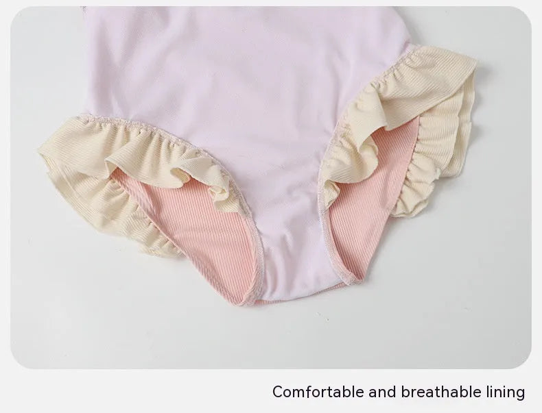 Pink women's conservative one-piece swimsuit made from nylon fabric on a mannequin.