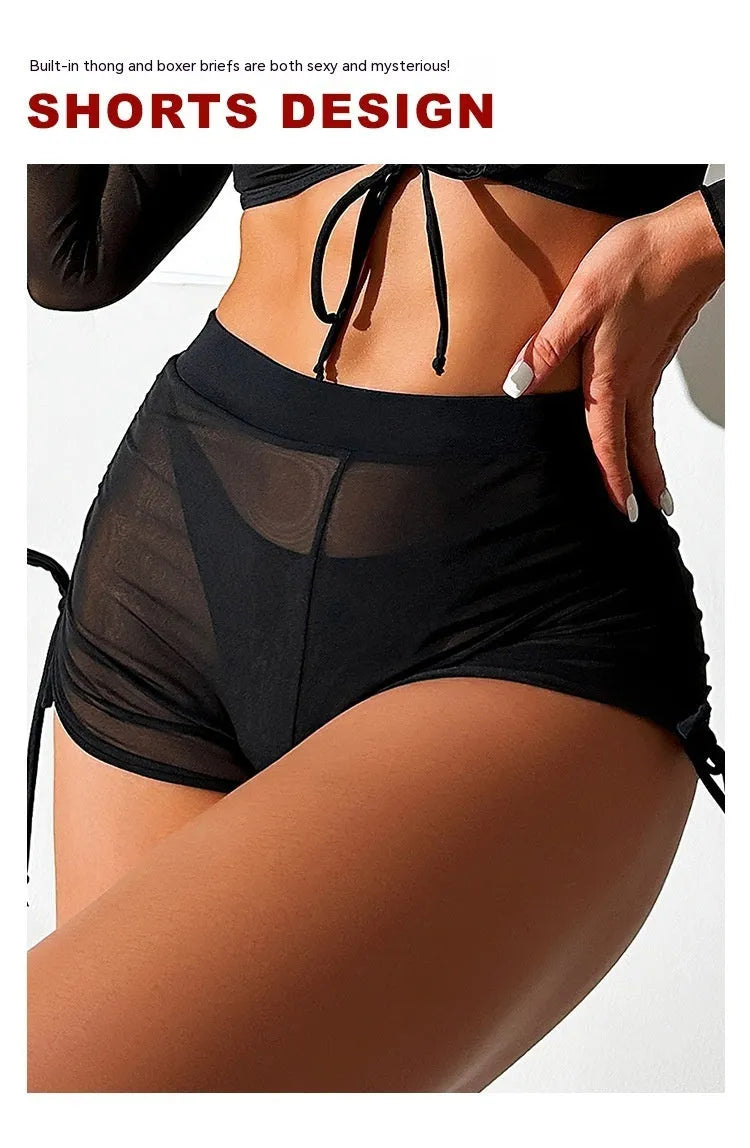 Black mesh women's four-piece bikini set with long sleeve top on a mannequin