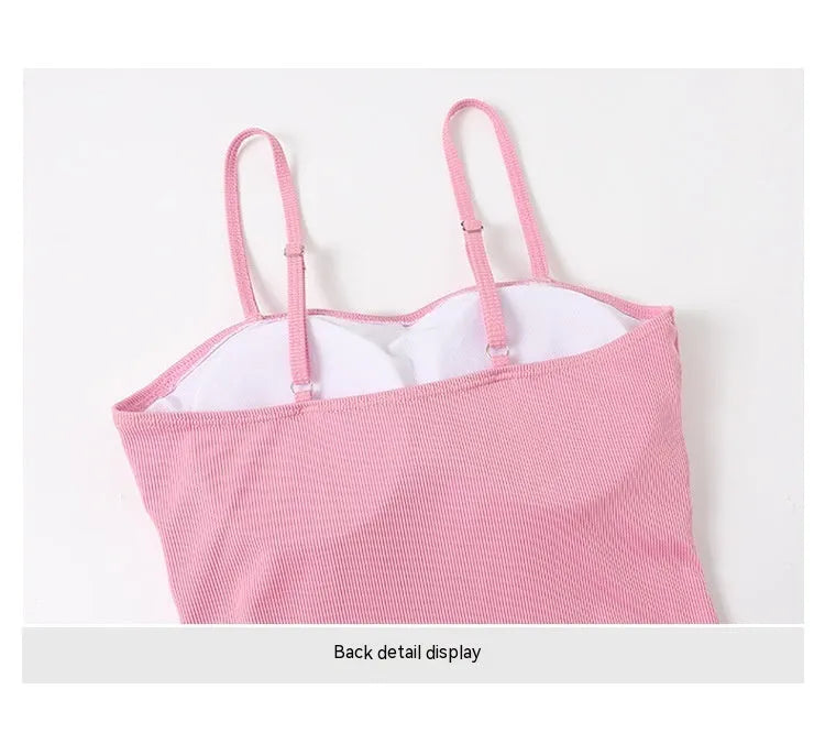 Women's long sleeve one-piece swimsuit in pink and black, made from polyester fabric.