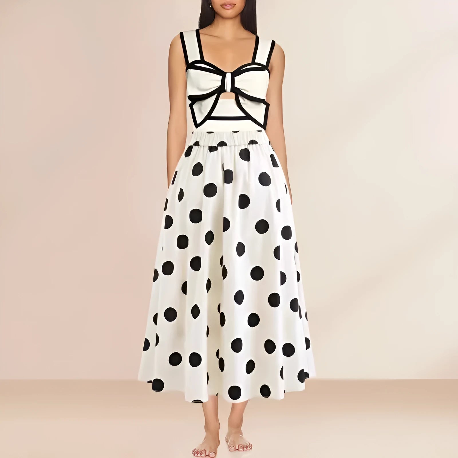 Women's black one-piece swimsuit with a white bow-accented beach dress cover-up skirt.