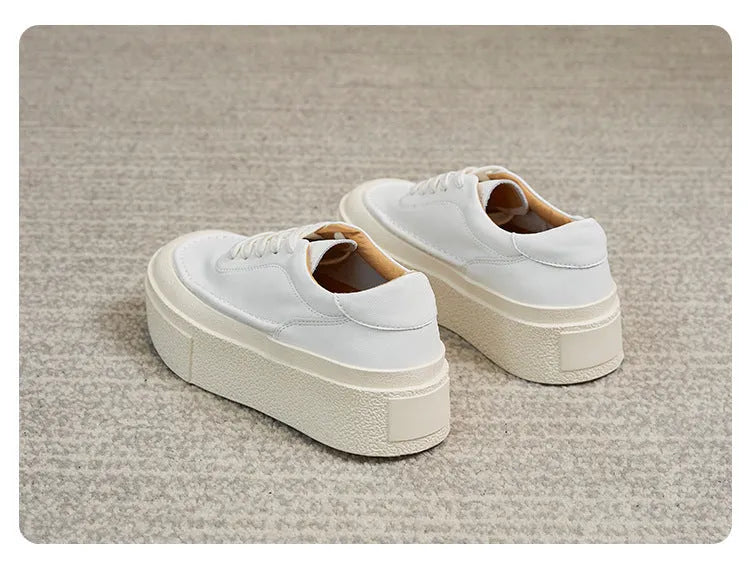 Women's black platform sports shoes with embossed cowhide upper and rubber sole, tied design detail
