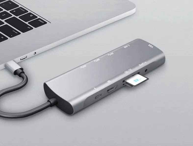Grey USB-C docking station with HDMI, VGA, and USB 3.0 ports on aluminium alloy body
