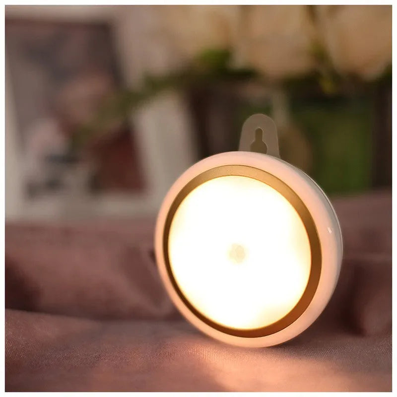 Round white motion sensor LED light unit with 80mm diameter, for cupboard or wall mounting.