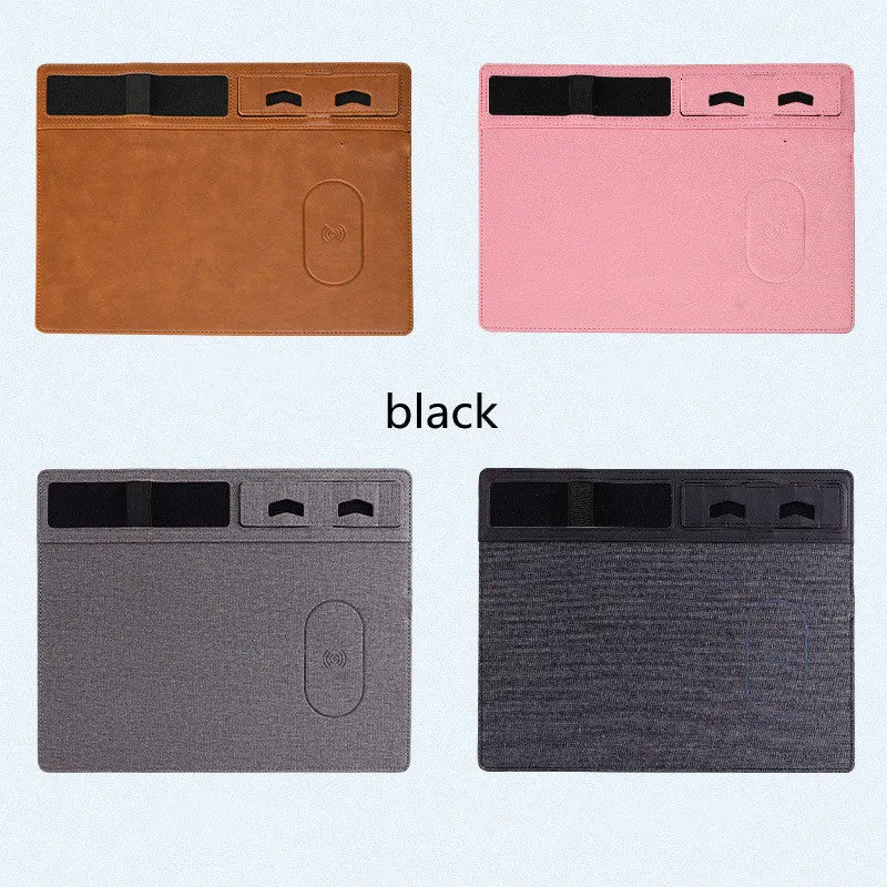 Pink wireless charging mouse pad with phone holder on a desk, showing USB cable connection