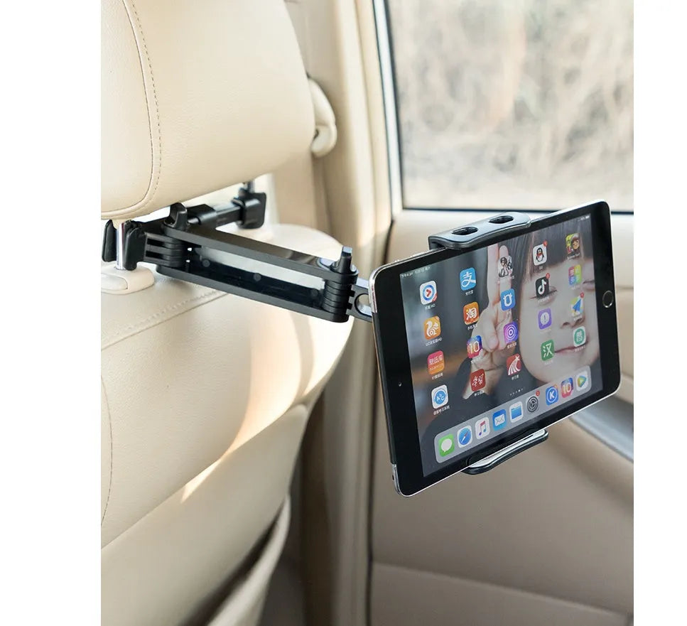 Black universal car phone holder mounted on vehicle rear seat base with tablet secured in snap-in mechanism