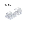 Transparent self-adhesive plastic snap clips for cable management on a white background.