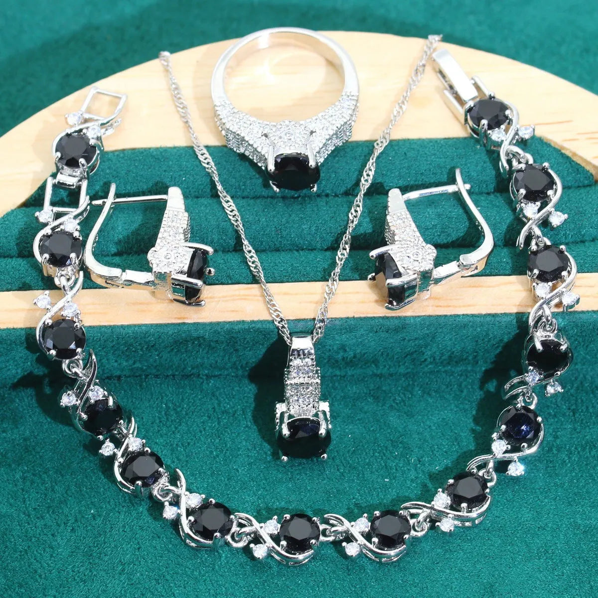 Four-piece bridal jewellery set showing necklace, earrings, ring, and bracelet with zircon alloy pendants