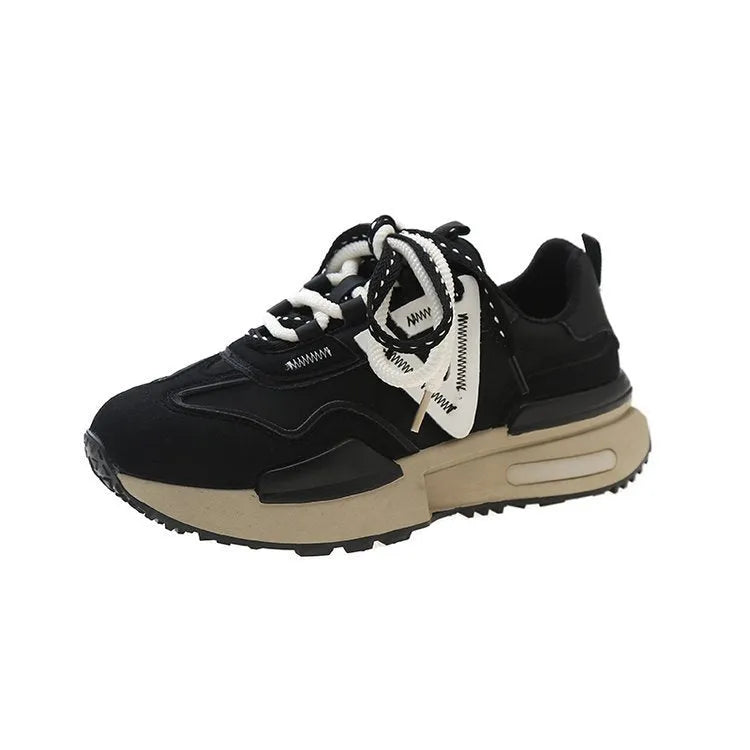 Women's retro platform sports shoes in black with mesh lining and rubber sole, shown from the side.
