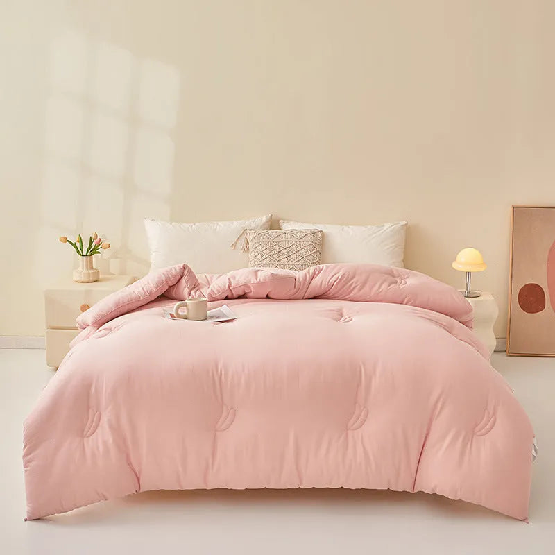 A pure cotton soybean fibre airable quilt in grey, shown with a zipper detail, on a bed.