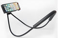 White universal smartphone stand with 360° rotating clamp holding mobile phone