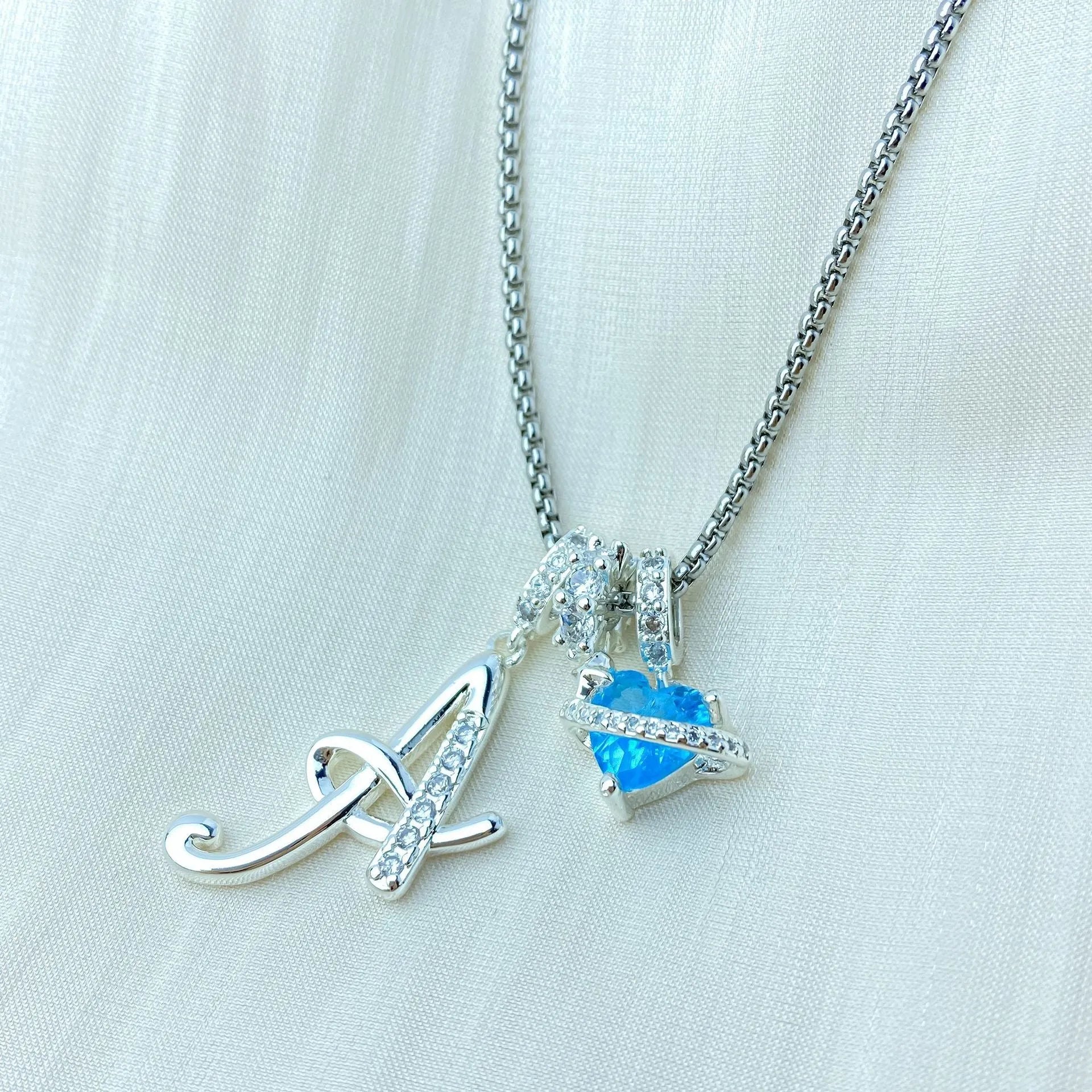 Copper English letter necklace with 26 alphabet charms in gold and silver style on display
