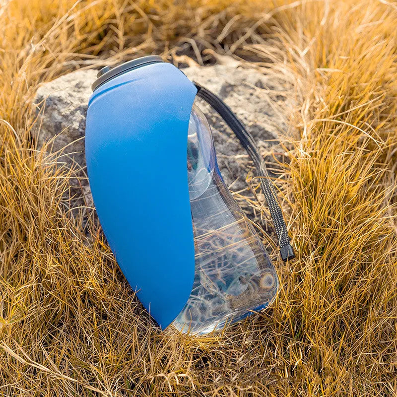 Blue portable pet water bottle with fold-out drinking bowl and carabiner clip for outdoor use