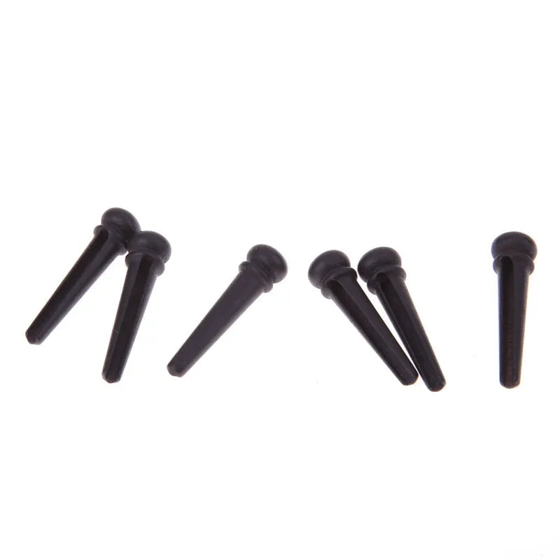 Six ebony guitar string nails with matt black finish for folk acoustic guitar bridge installation