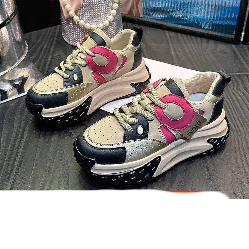 A pair of thick-soled leather casual shoes with a wedge heel and round toe in a lace-up design.