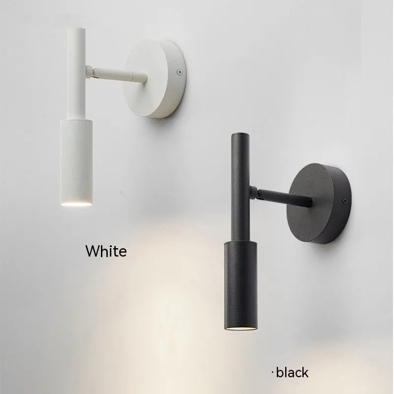 Modern wrought iron wall lamp in black or white, 100mm by 230mm, with three colour light options.