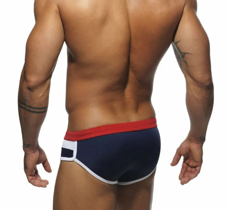 Men's nylon patchwork swim trunks in black, dark blue, and pink, available in sizes M to XXL