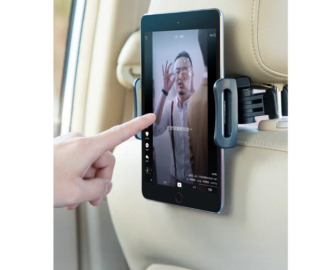Black universal car phone holder mounted on vehicle rear seat base with tablet secured in snap-in mechanism