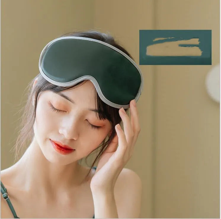 Pink and green portable eye SPA massage goggles showing USB port and suede exterior.