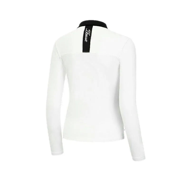 Women's slim-fit long sleeve polyester golf top in black on a hanger.