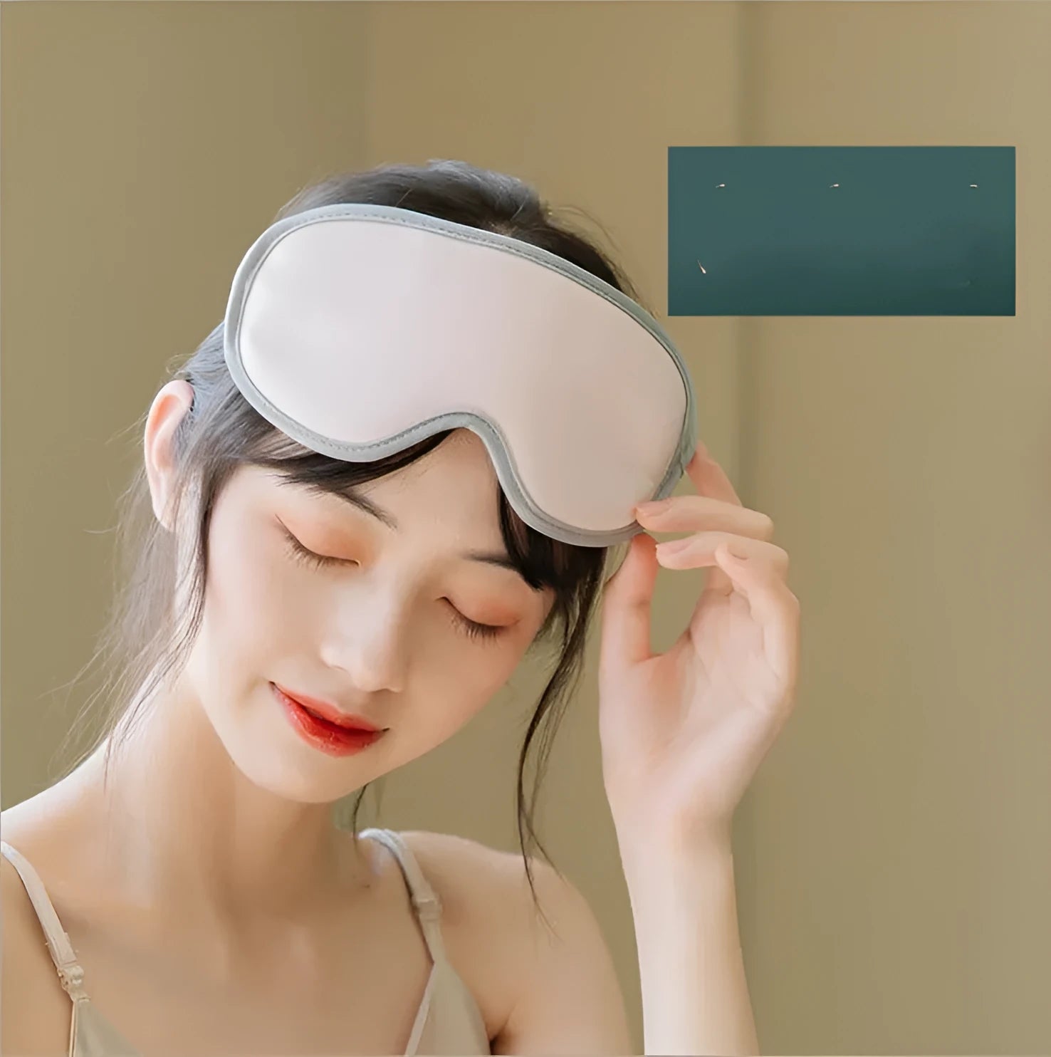 Pink and green portable eye SPA massage goggles showing USB port and suede exterior.