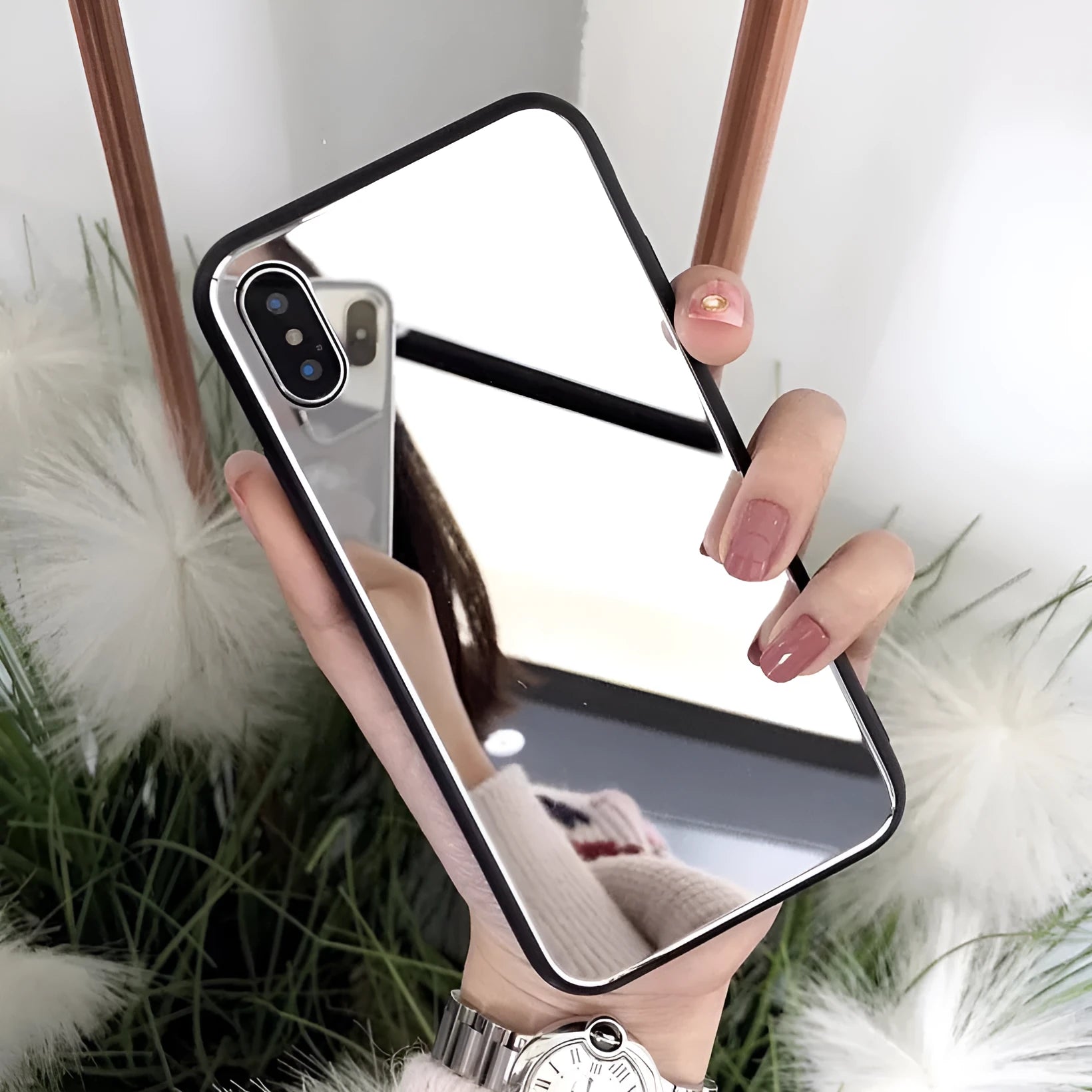 Black mirrored back cover phone case for Apple iPhone models on a table.