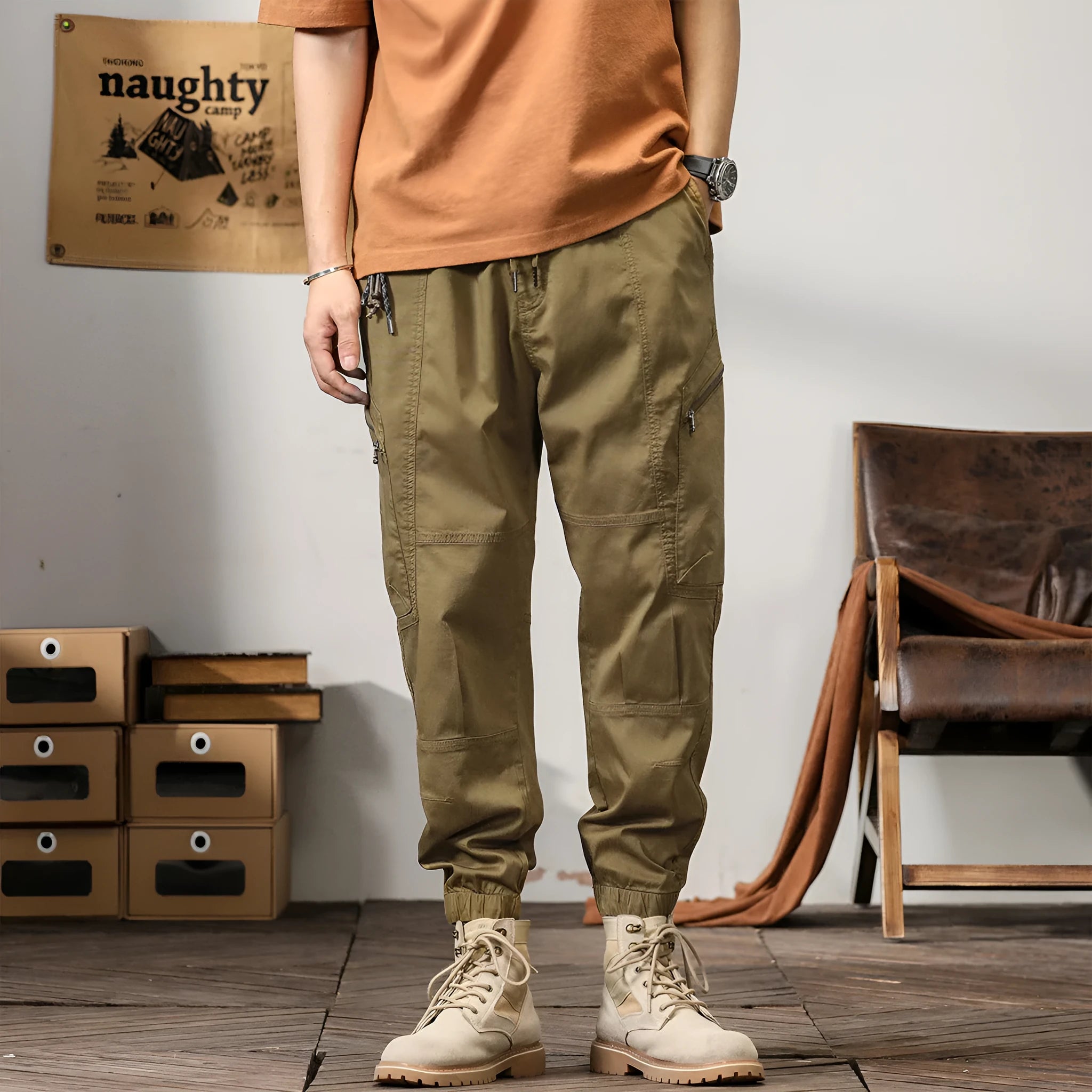 Men's khaki cotton tapered harem pants with an ankle band and loose fit.