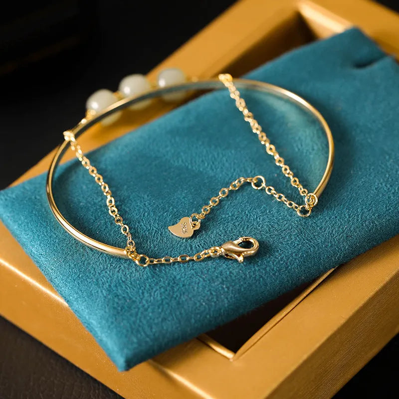 Women's jade bracelet with gold inlay detailing showing single, double and three bead versions