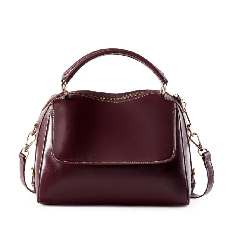 Women's soft genuine leather crossbody tote bag in a square shape with a double strap, shown in apricot colour.