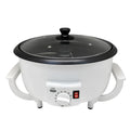 White electric coffee bean roasting machine with 750g capacity and oblate drum design on kitchen counter