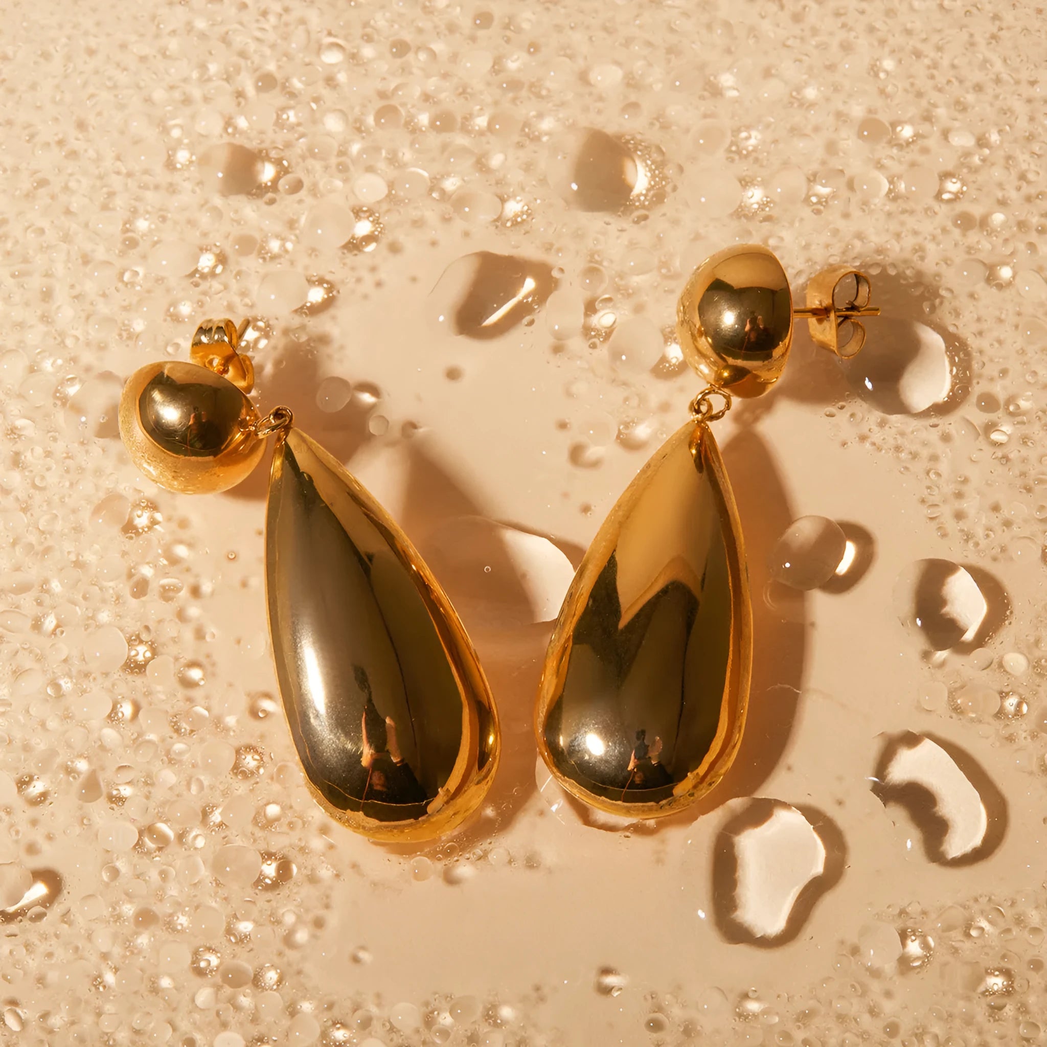 Gold stainless steel water drop pendant earrings with geometric hemisphere design for women