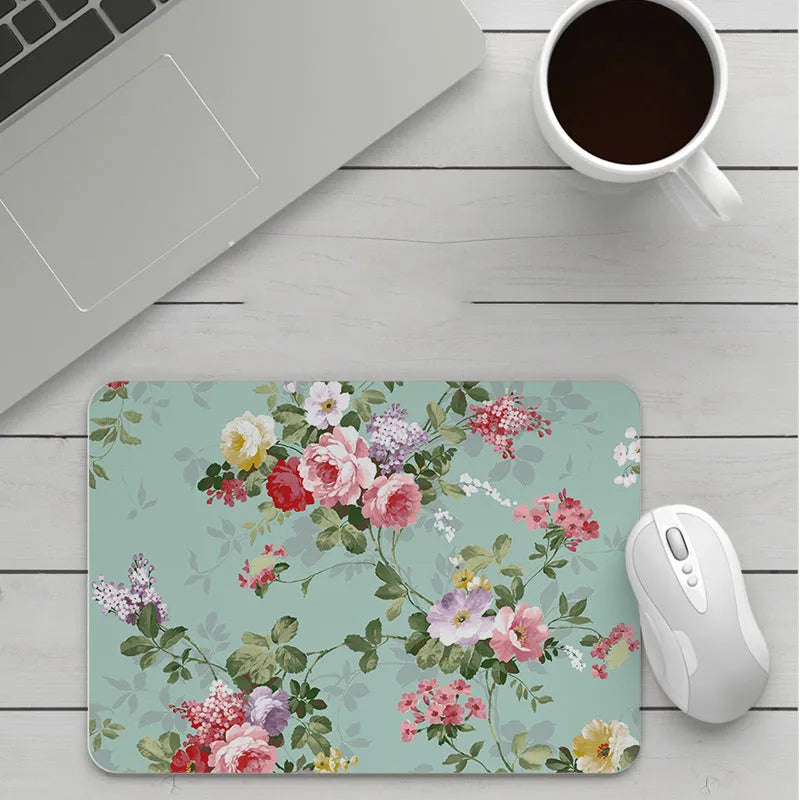 Custom cartoon thickening mouse pad on a desk, showing a colourful design with black stitched edge.