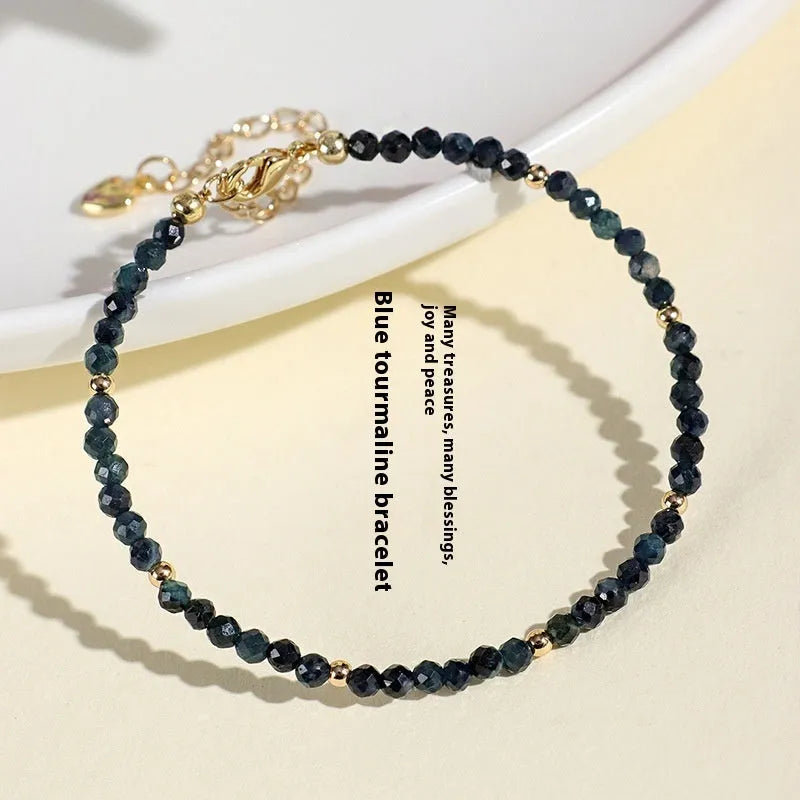 Blue tourmaline spacer bead bracelet with 3mm cut beads and blue gold accents