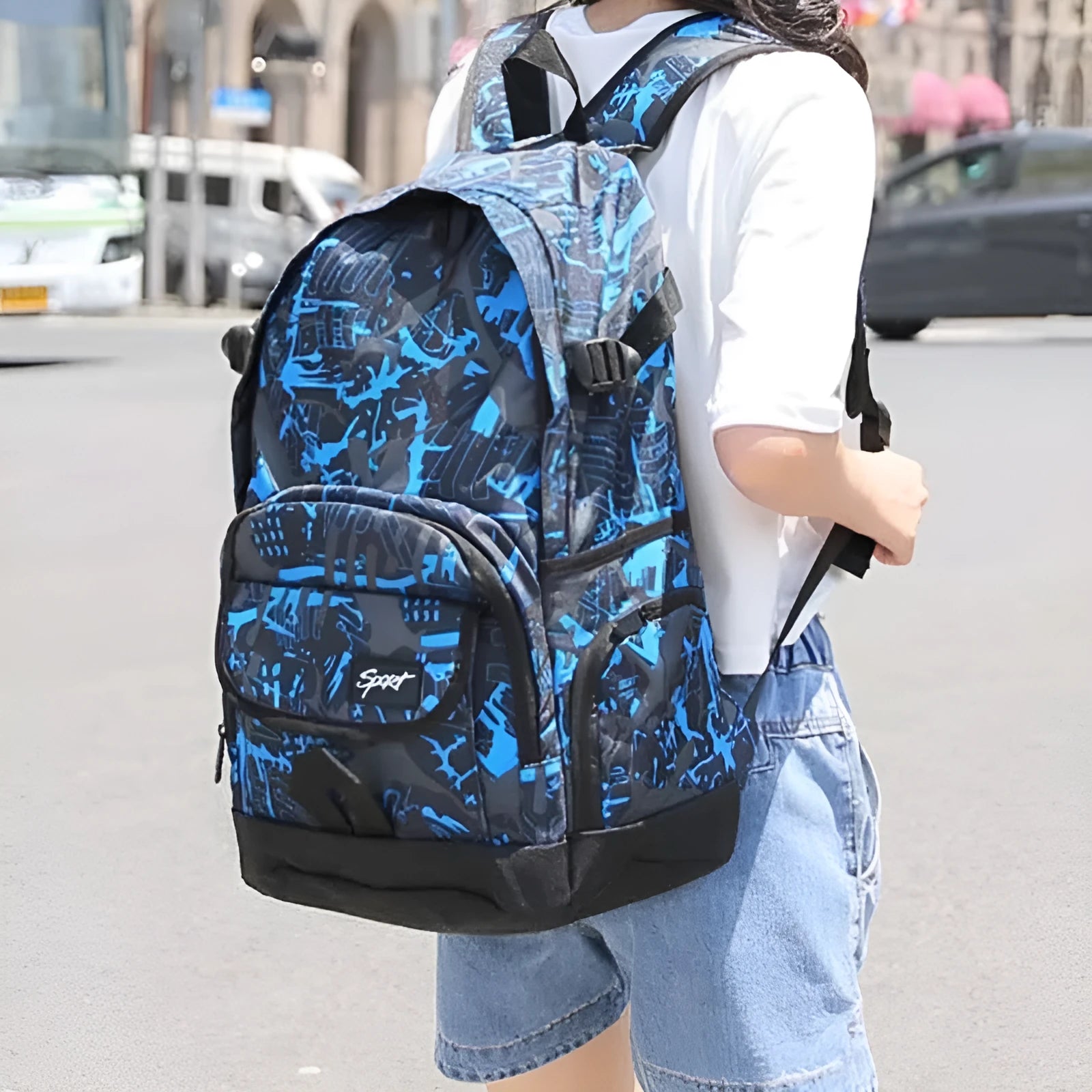 Blue and red large nylon backpack with multiple compartments open, showing internal organisation.