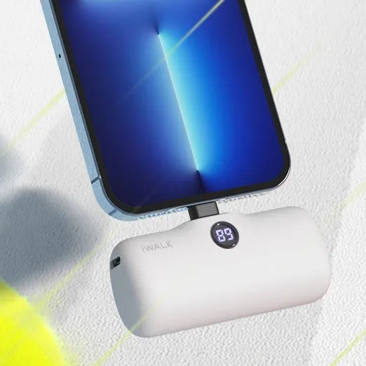 Compact cylindrical lipstick-style power bank showing colour options and display screen.