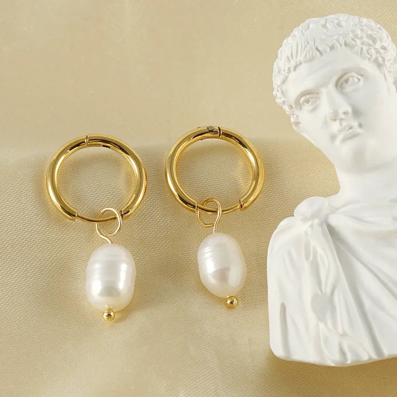 Geometric gold stainless steel earrings with pearl accents on white background