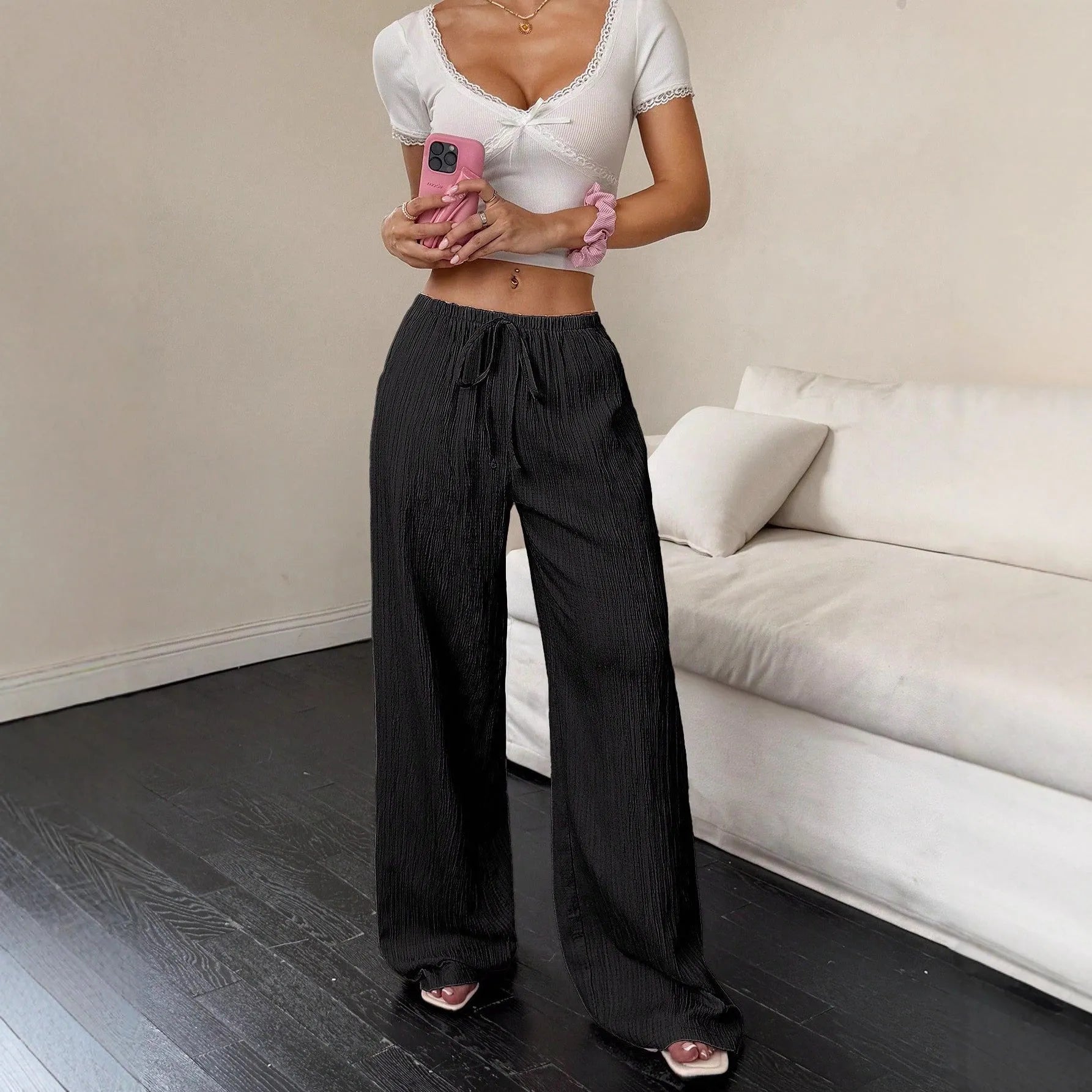 Women's black wide-leg trousers with lace-up waist detail on mid-waist