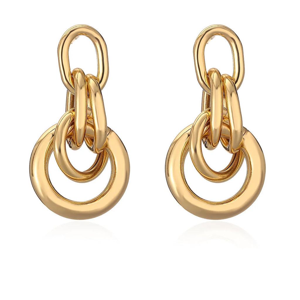 A pair of real gold coloured geometric earrings with an irregular shape, made from copper, style wild.